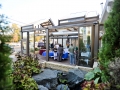 Restaurant patio structure with retractable roof and opening walls