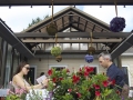 Patrons dining on a patio in the summer