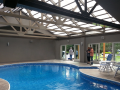 Swimming pool with opening roof